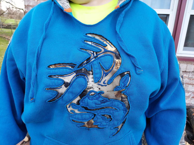 closeup of deerhead design on Legendary Whitetails Realtree camo hoodie.